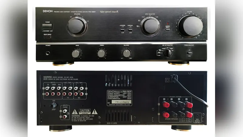 Headphones resting beside a hi-fi amplifier